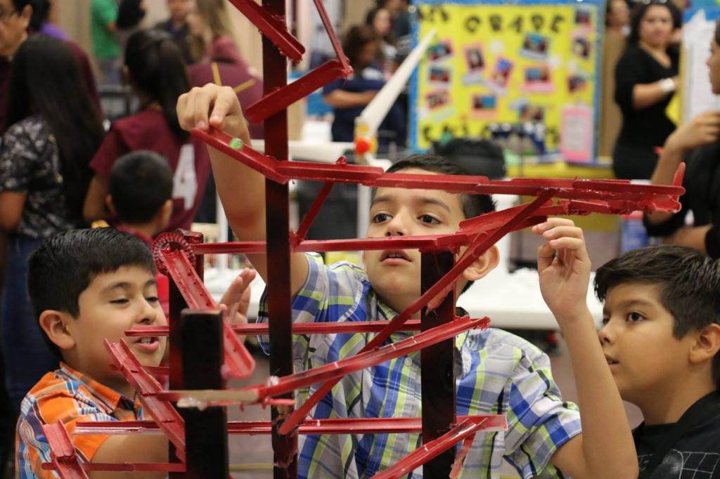 Students at a science fair exhibit