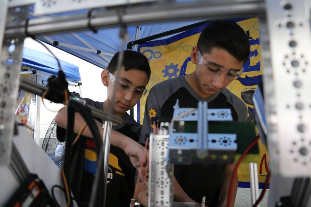 Two robotics students working on a project